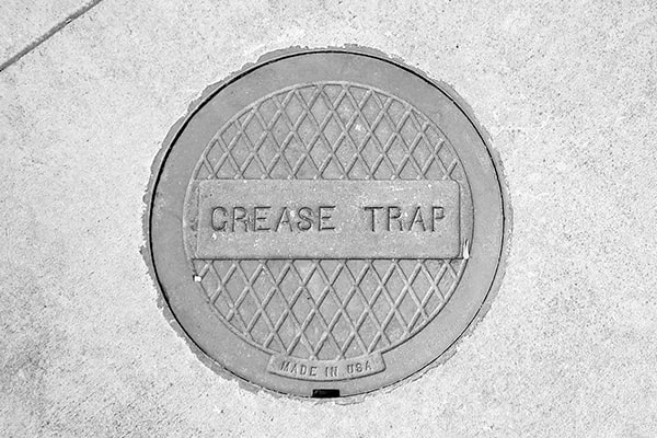 grease trap pumping prevents grease and oil from entering the sewer system, protecting the environment from pollution